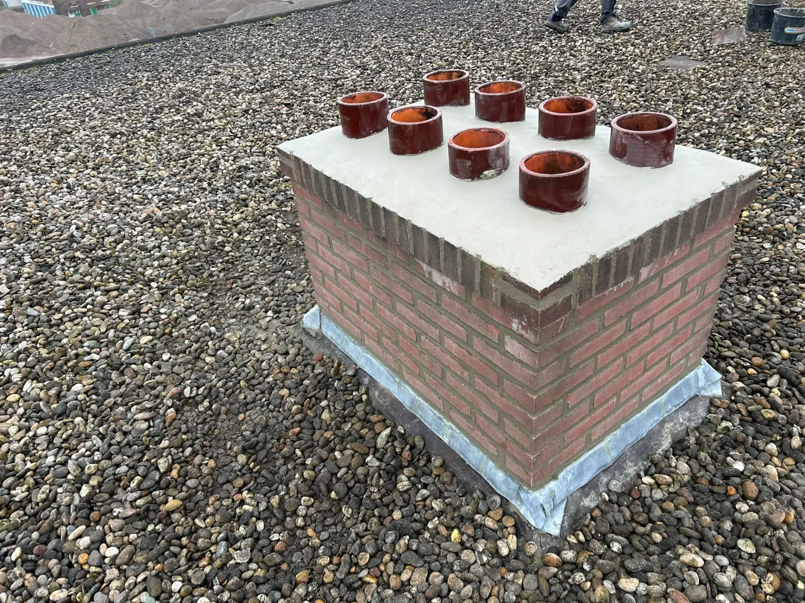 Opnieuw opgemetselde schoorsteen met zinken slabbe en stucafdekking