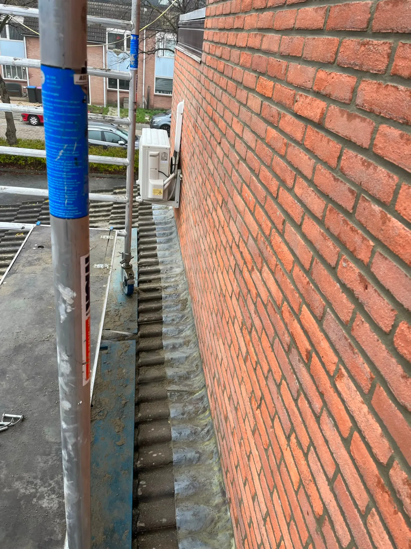 Vernieuwde loodaansluiting tussen dakvlak en bakstenen gevel